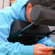 A man uses the gaming cushion.